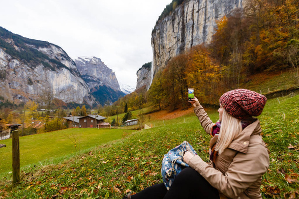 Young girl in lauterbrunnen in Switzerland with panoramic view of Swiss alps - Photo, Image