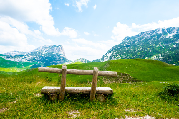 wooden bench with beautiful mountains in Durmitor massif, Montenegro - Photo, Image