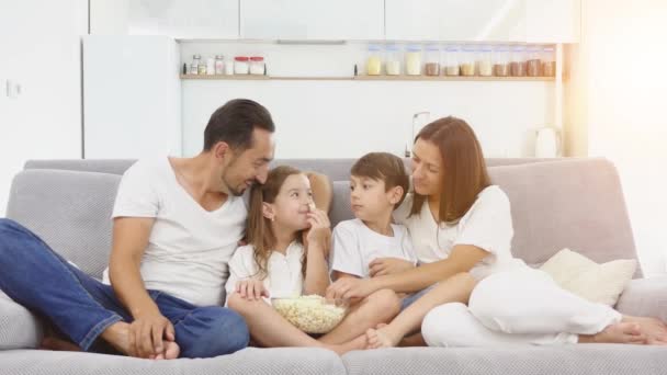 happy family play with popcorn on the couch - Filmmaterial, Video