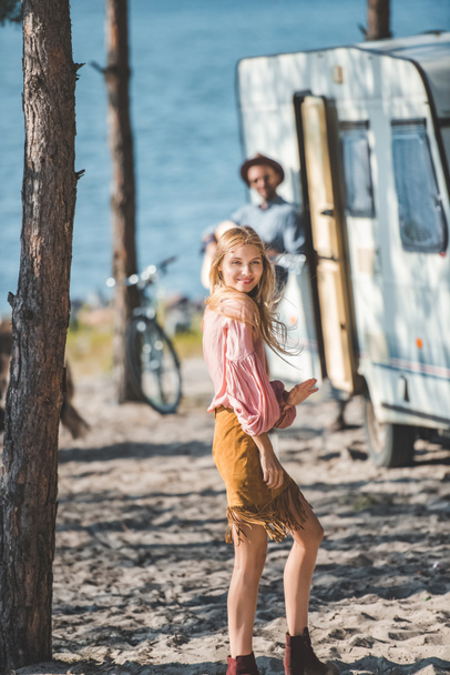 attractive young woman dancing while man playing guitar near campervan - Photo, Image