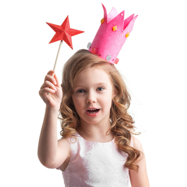 Beautiful little candy princess girl in crown holding star shaped magic wand and making a wish - Fotografie, Obrázek