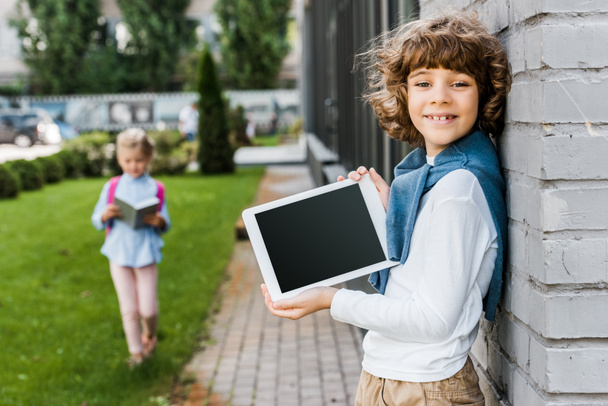 cute happy boy holding digital tablet with blank screen and smiling at camera - Fotoğraf, Görsel