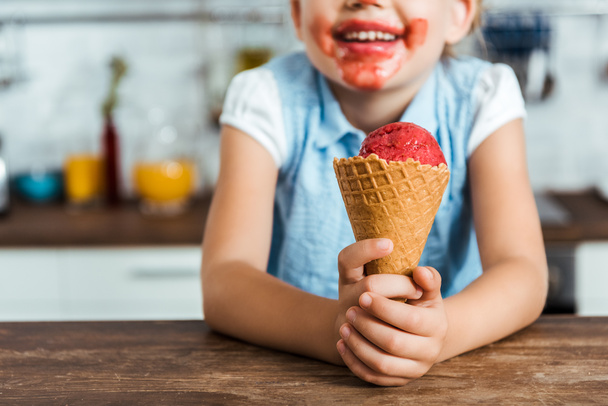 cropped shot of adorable happy child holding delicious ice cream cone - 写真・画像