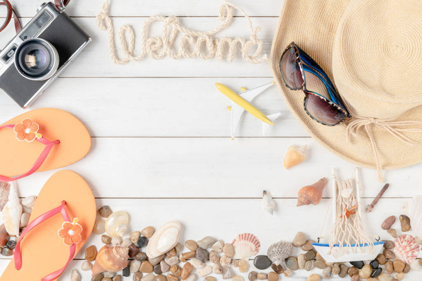 welcome text with hat, sandals and seashell on old white wood background, summer travel concept - Valokuva, kuva
