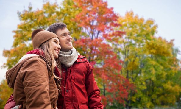 happy teenage couple hugging in autumn park - Φωτογραφία, εικόνα