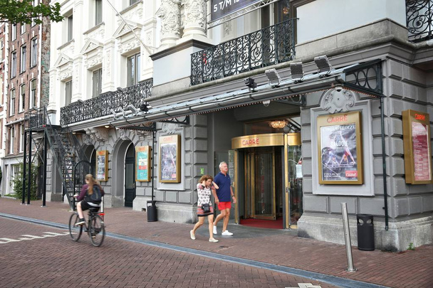 AMSTERDAM, NETHERLANDS - JULY 10, 2017: People walk by Royal Theatre Carre in Amsterdam, Netherlands. The theatre was founded in 1887. - Zdjęcie, obraz
