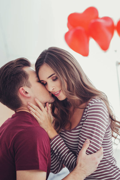 Portrait of young man kissing his amazing girlfriend - Photo, Image