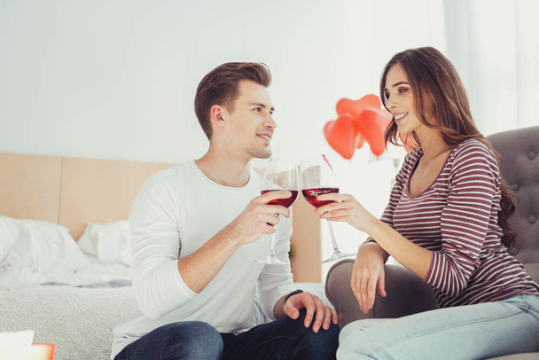 Waist up of adorable couple drinking wine together - Zdjęcie, obraz