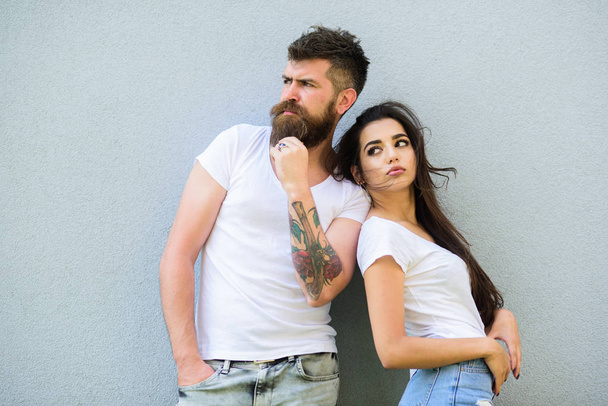 Couple stylish youth. Couple white shirts cuddle each other. Romantic couple. Couple in love hang out together grey wall background. Hipster bearded and stylish girl hang out urban romantic date - Photo, Image