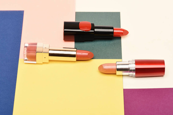 Beauty supplies, lipstick, copy space. Three red, scarlet lipsticks - Photo, image