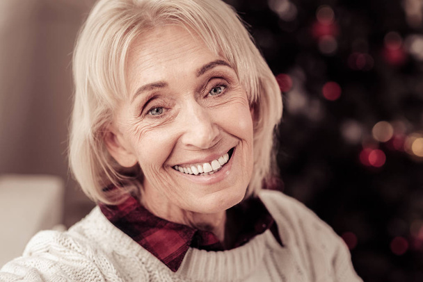 Satisfied aged woman looking straight and smiling. - Fotoğraf, Görsel
