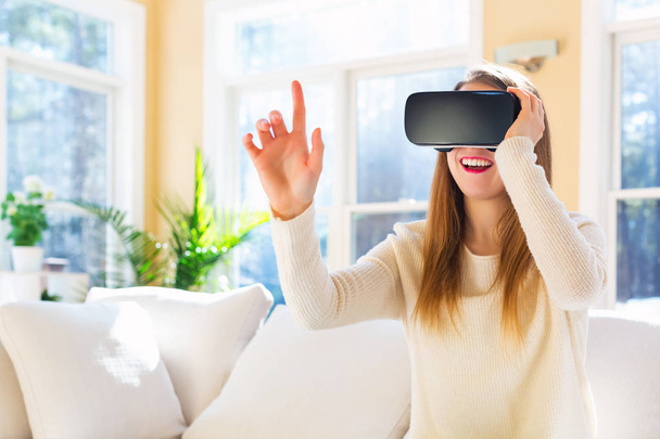 Young woman using virtual reality headset - Foto, imagen