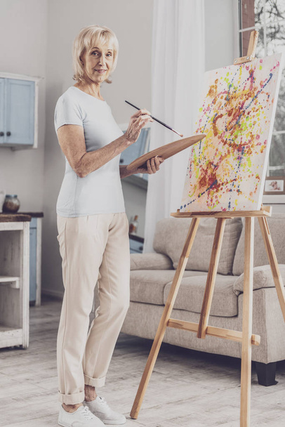 Woman wearing stylish beige trousers drawing picture - Fotó, kép