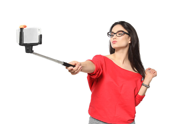 Attractive young woman taking selfie on white background - Valokuva, kuva