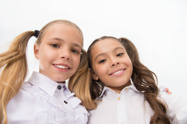 Schoolgirls with cute ponytails hairstyle and brilliant smiles. Best friends excellent pupils. Perfect schoolgirls with tidy appearance. Shine bright. School fashion and style. Take selfie photo - Φωτογραφία, εικόνα