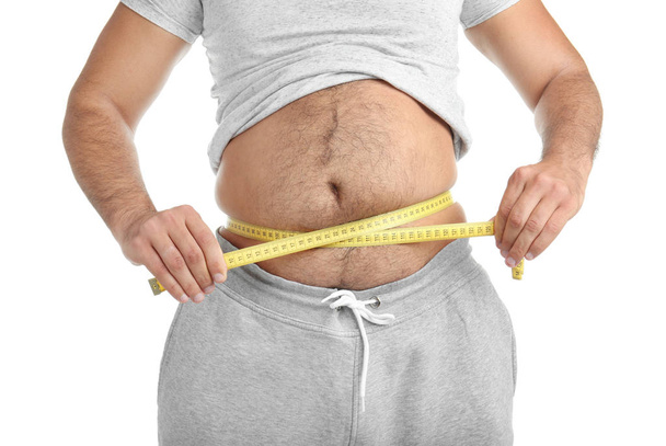 Overweight man with measuring tape on white background, closeup - Photo, image