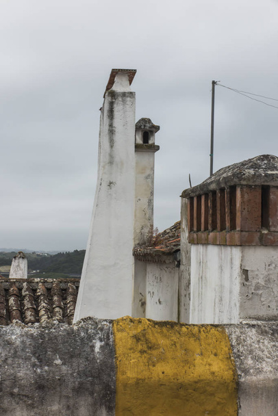 Different chimney designs in the old town of Obidos in Portugal as an architectural curiosity - Photo, Image
