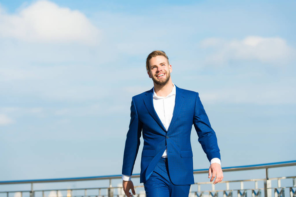 Success his second name. Businessman successful entrepreneur in suit walks outdoor sunny day sky background. Man confident and well groomed enjoy freedom. Luck and success concept. Feel superior - Photo, image