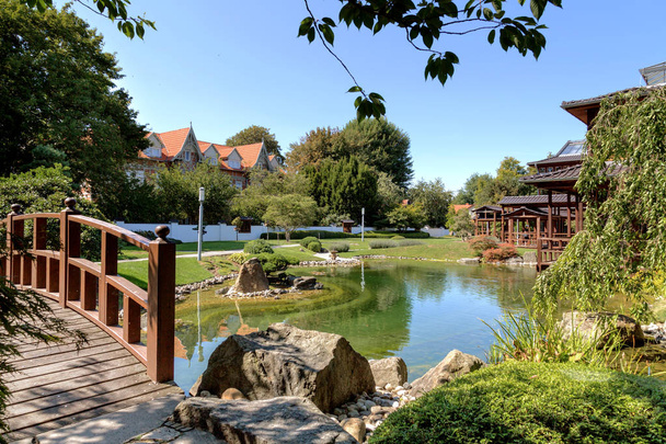 corner in a japanese park with a bridge, a pavilion and a pond in a traditional national style - Photo, Image
