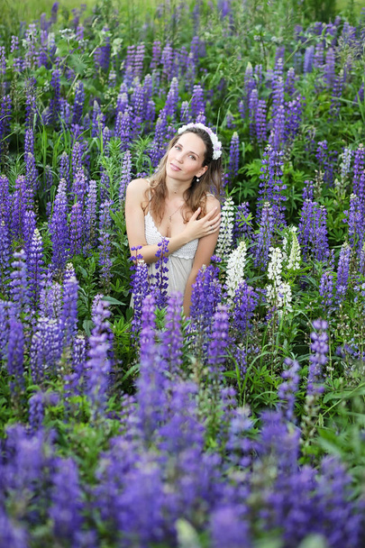 Girl with a bouquet of blue flowers - Zdjęcie, obraz