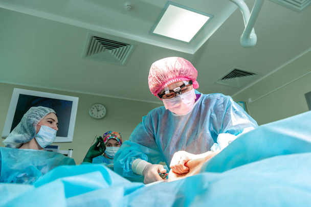 Surgeons team working in hospital. Group of surgeons in the operating room during surgery - Photo, Image