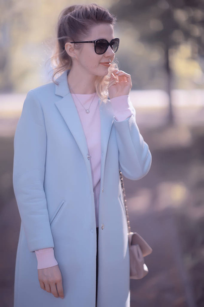 beautiful blonde woman wearing stylish coat in park  - Фото, зображення