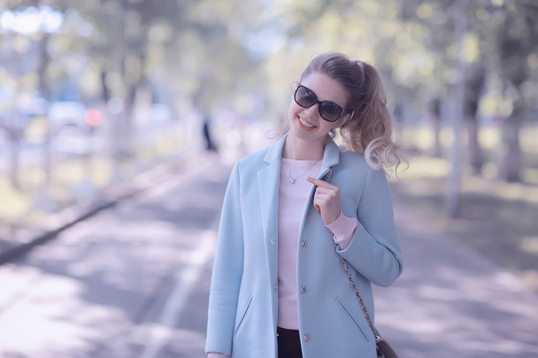 portrait of young happy woman wearing stylish coat in spring park  - Fotoğraf, Görsel