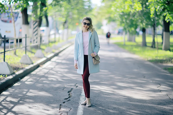 beautiful blonde woman wearing stylish coat in park  - Fotó, kép