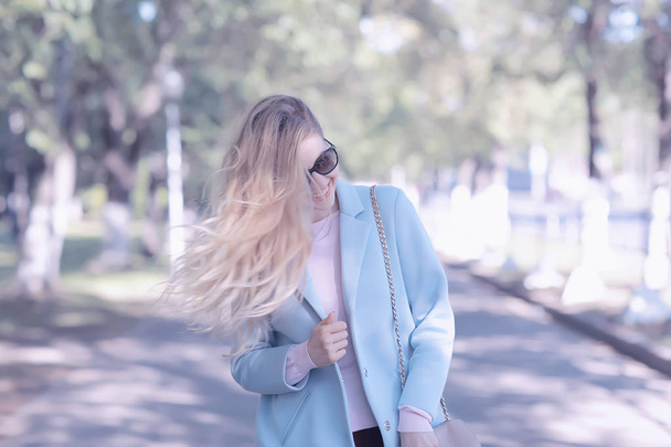 beautiful blonde woman wearing stylish coat in park  - Фото, зображення