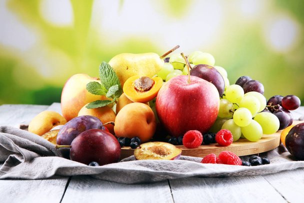 Fresh summer fruits with apple, grapes, berries, pear and apricot. - Photo, image