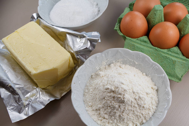 Eggs, butter, flour and sugar to make a cake - Photo, Image