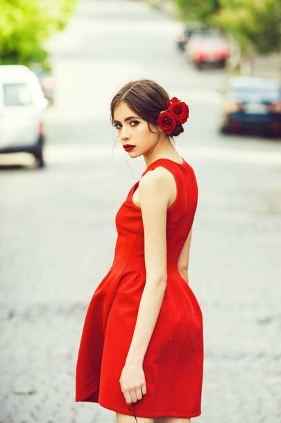woman in stylish, red dress walking on road - Valokuva, kuva