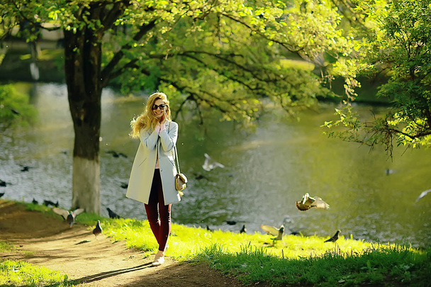 beautiful blonde woman wearing stylish coat in park  - Photo, image