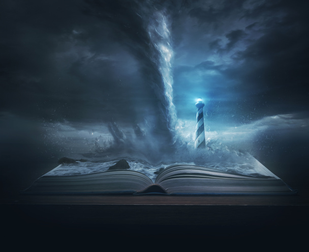 A big storm and tornado on top of the pages of a Bible with a bright lighthouse - Photo, Image