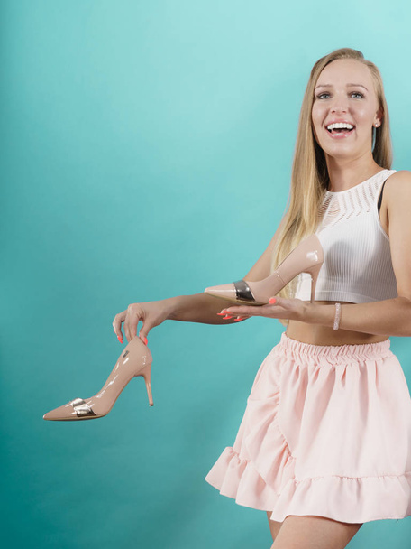 Teenage woman fashion stylist presenting her elegant shoes. Beautiful pink sensual high heels. Outfit accessories - Zdjęcie, obraz