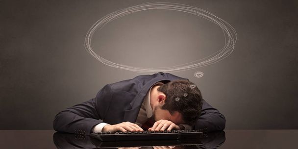 Businessman sleeping and dreaming at his workplace - 写真・画像