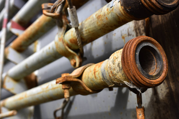 An abstract image of old rusted industrial pipes on a rack.  - Photo, Image