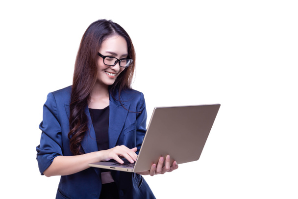 Attractive beautiful businesswoman is working on laptop. Charming beautiful business woman feels happy of work with smiley face. Technology of internet make her getting successful of business isolate - Photo, Image