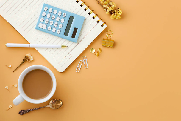 Woman workspace background with calculator, notebook, pen and coffee cup from top view - Photo, Image