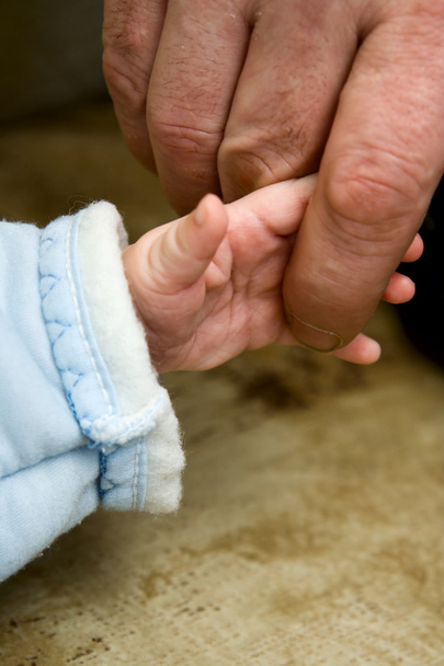 Small child keeping finger of father - Φωτογραφία, εικόνα