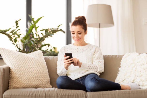 woman with smartphone at home - Foto, Imagen