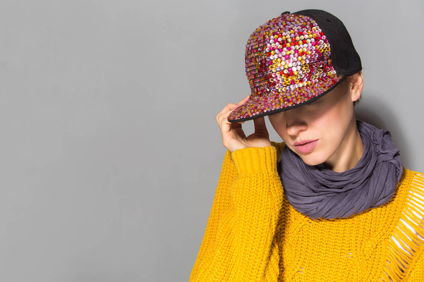 Portrait of a teenage girl posing wearing trendy autumn outfit  bright sweater, scarf and cap hat isolated over grey background - Fotoğraf, Görsel