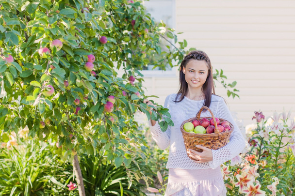 beautiful girl with apple in garden - Photo, image