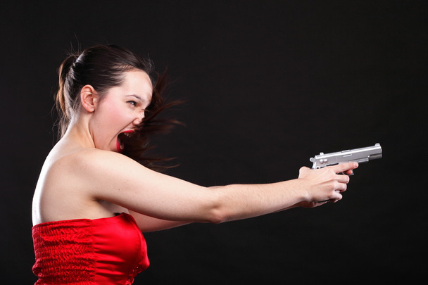 Sexy young woman - gun on black background - Foto, imagen