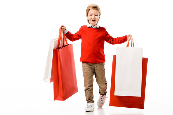 счастливый маленький ребенок держит большие сумки, изолированные на белом
 - Фото, изображение