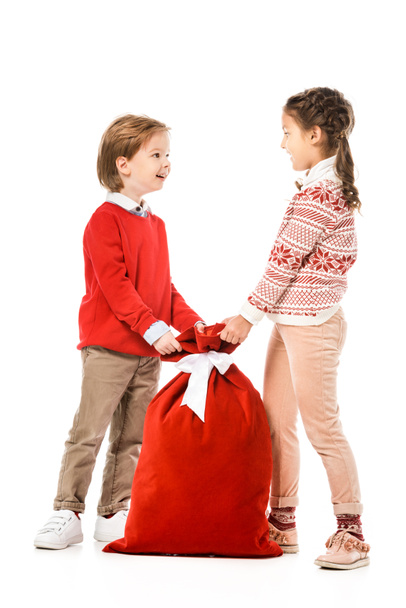 adorable little kids with santa gift sack isolated on white - Photo, Image