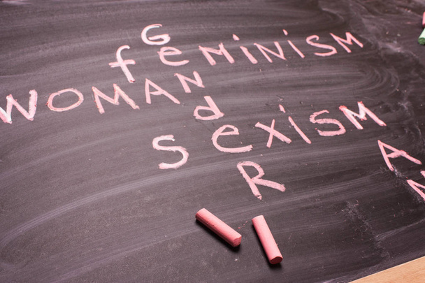 Words gender, sexism, feminism written in pink chalk on a chalkboard - Photo, Image