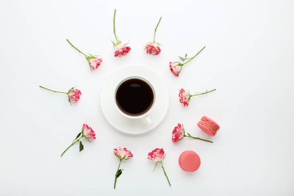 Rose flowers with cup of coffee and macarons on white background - Fotoğraf, Görsel