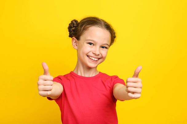 Cute young girl on yellow background - Фото, изображение
