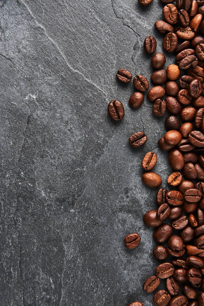Coffee beans on dark stone table. Flat lay with copy space. - Foto, Imagem